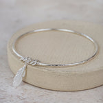 Sterling Silver Feather Charm Bangle handmade by Lucy Kemp Jewellery