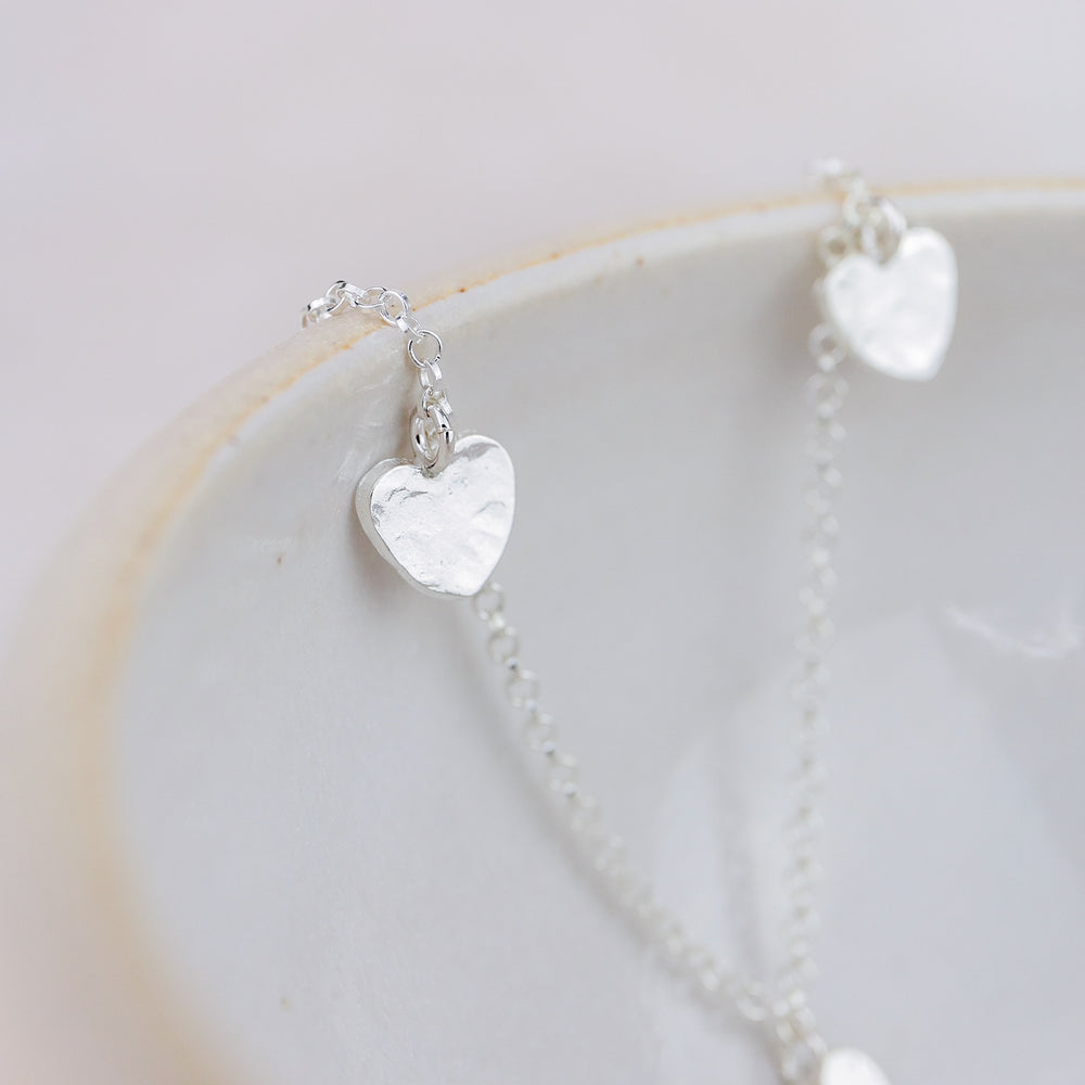 
                  
                    Sterling Silver Three Heart Charm Necklace
                  
                