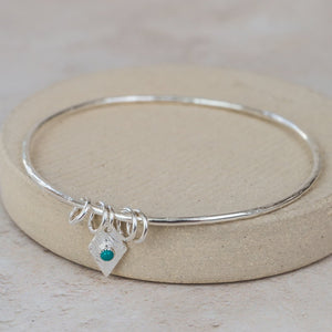 
                  
                    Sterling Silver Diamond and Turquoise Charm Bangle
                  
                