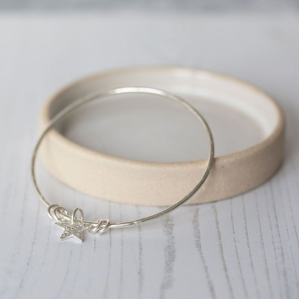 
                  
                    sterling silver textured star charm bangle handmade by Lucy Kemp Jewellery
                  
                