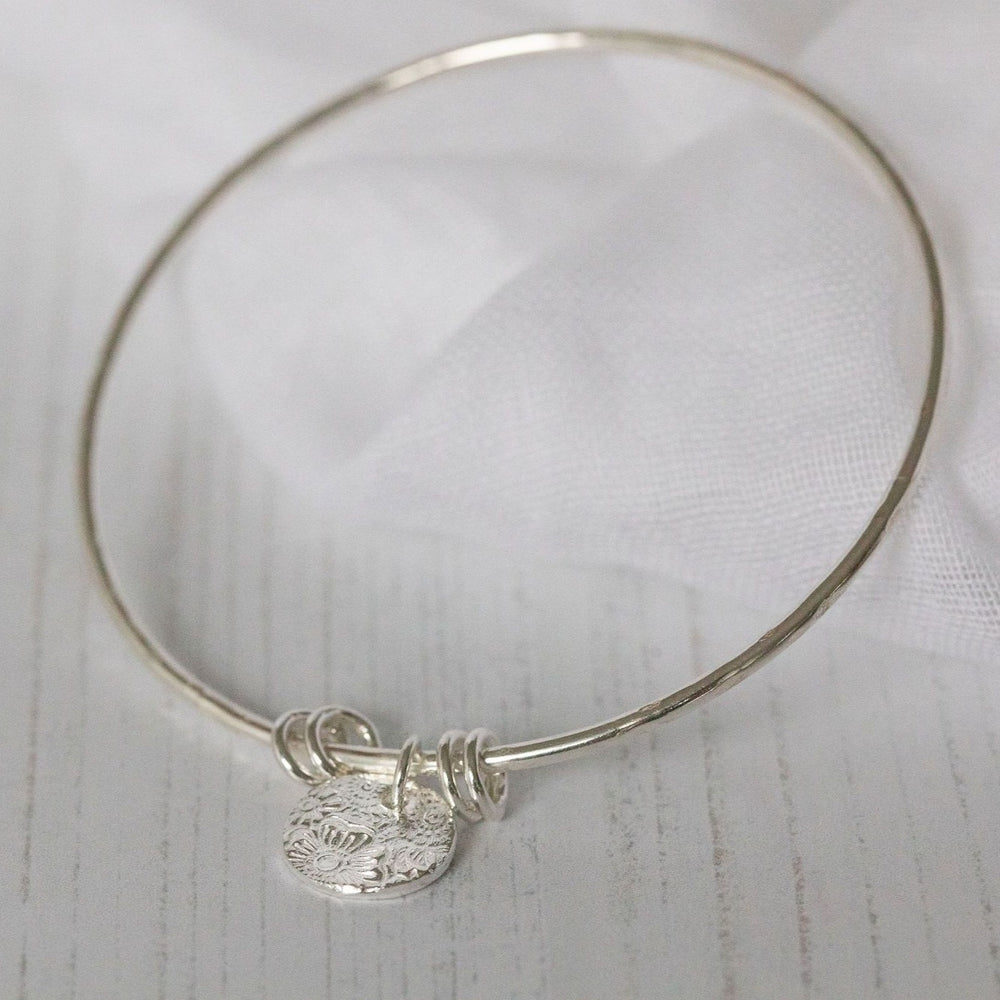 
                  
                    sterling silver textured circle charm bangle handmade by Lucy Kemp Jewellery
                  
                