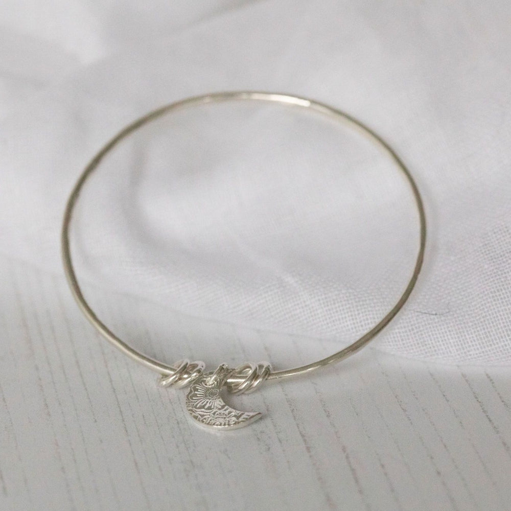 
                  
                    sterling silver textured moon charm bangle handmade by Lucy Kemp Jewellery
                  
                
