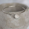 sterling silver textured circle charm bangle handmade by Lucy Kemp Jewellery