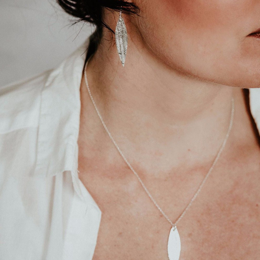 
                  
                    sterling silver textured palm leaf collection by Lucy Kemp Jewellery worn
                  
                