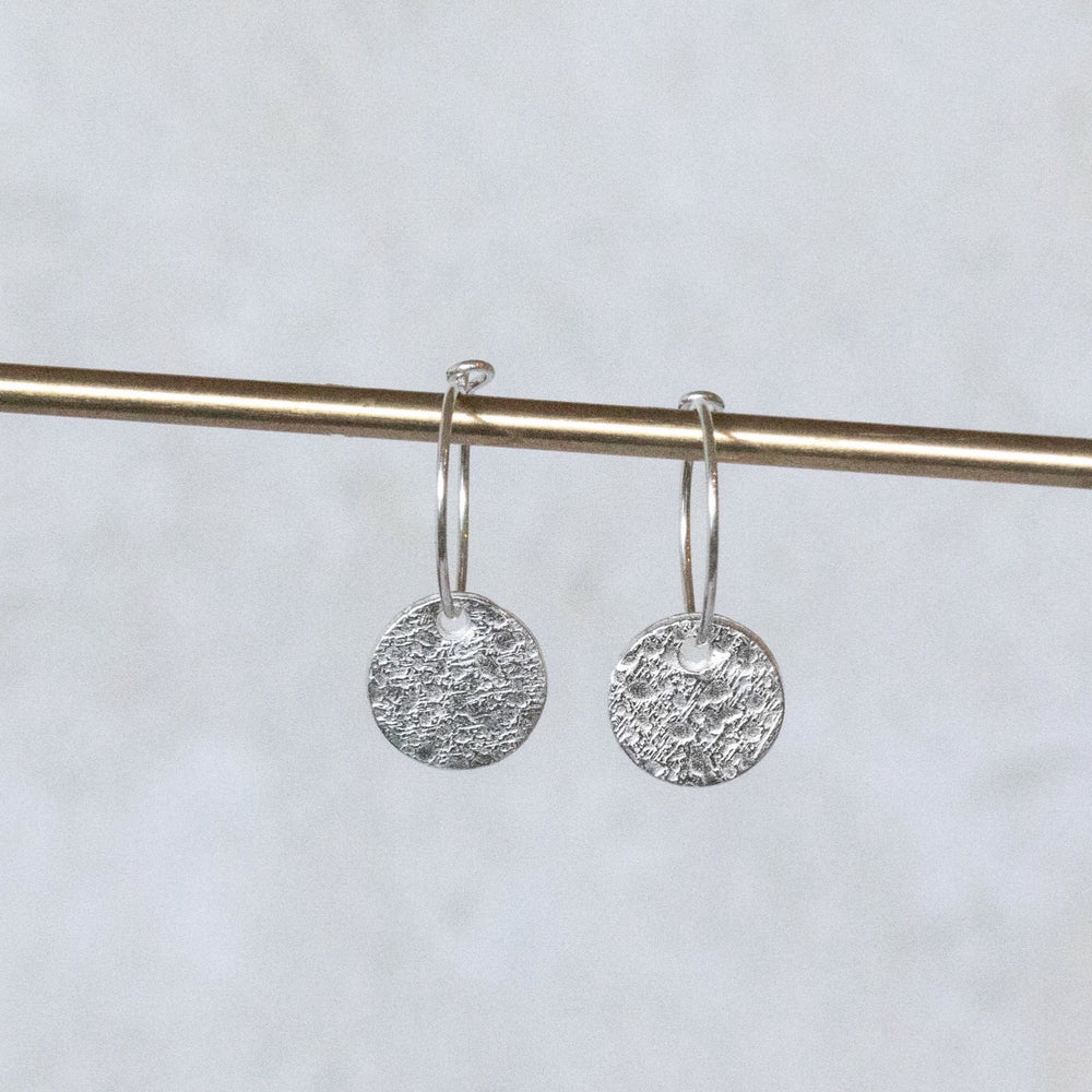 
                  
                    sterling silver textured circle charm hoops
                  
                