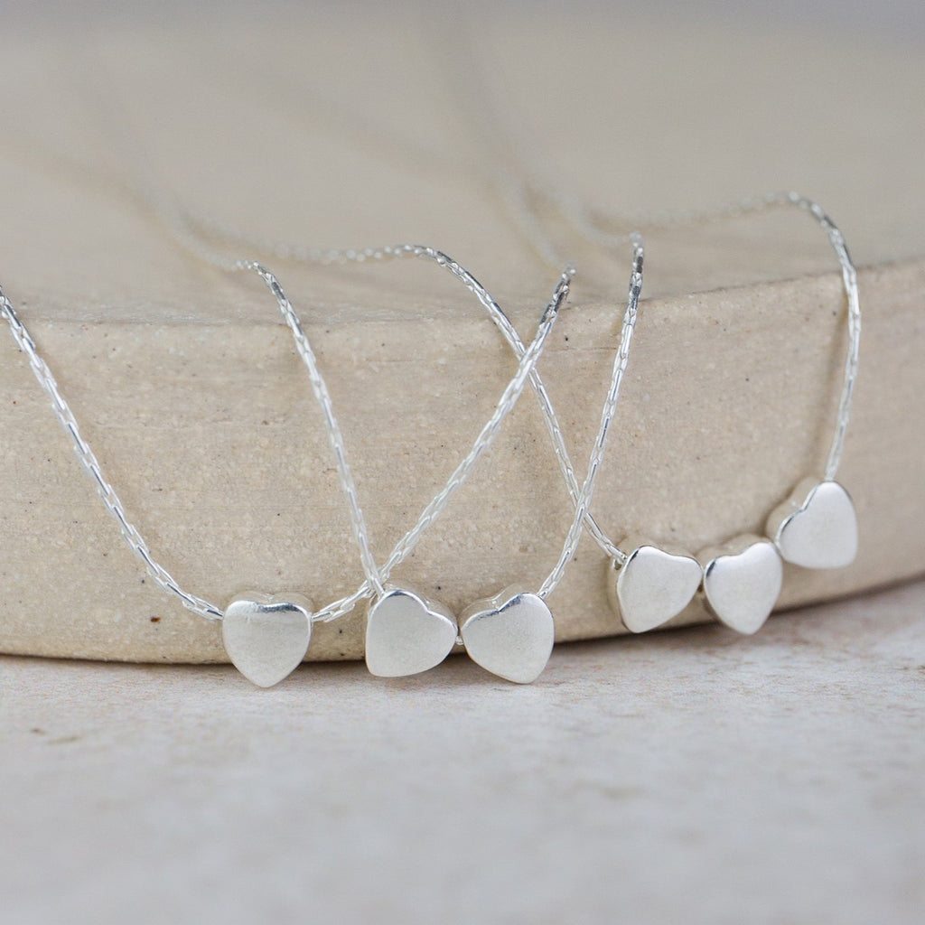 sterling silver heart bead charm necklace handmade by Lucy Kemp Jewellery - group shot of 1, 2 and 3 heart bead charms