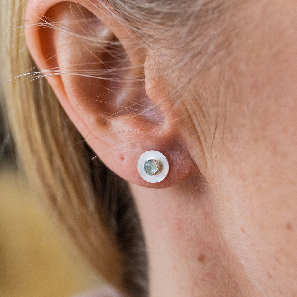 Worn Aquamarine and sterling silver birthstone small disc studs by Lucy Kemp Jewellery