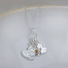 sterling silver and citrine birthstone cluster necklace with hearts and flower charm by Lucy Kemp Jewellery