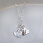 sterling silver and citrine birthstone cluster necklace with hearts and flower charm by Lucy Kemp Jewellery