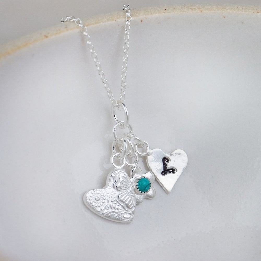 sterling silver and turquoise birthstone cluster necklace with hearts and flower charm by Lucy Kemp Jewellery 