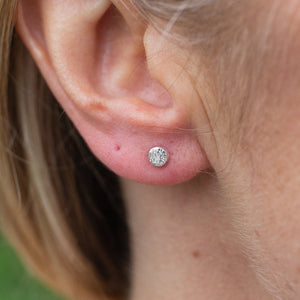 
                  
                    mini circle textured sterling silver studs worn, handmade by Lucy Kemp Jewellery 
                  
                
