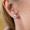 Worn Crystal Quartz and sterling silver birthstone small disc studs by Lucy Kemp Jewellery