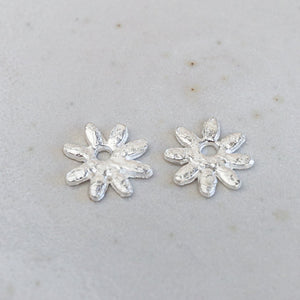 
                  
                    sterling silver textured daisy charms
                  
                