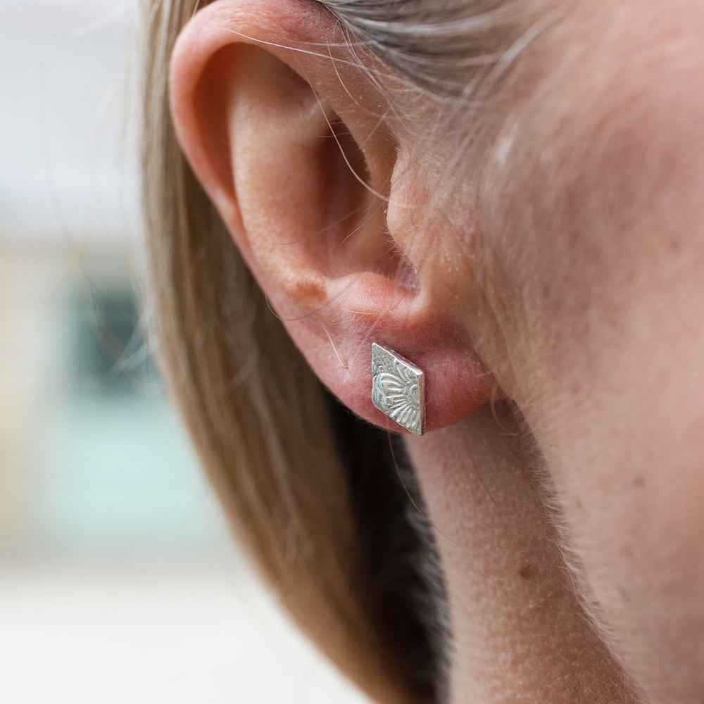 
                  
                    sterling silver textured diamond studs worn by Lucy Kemp Jewellery 
                  
                