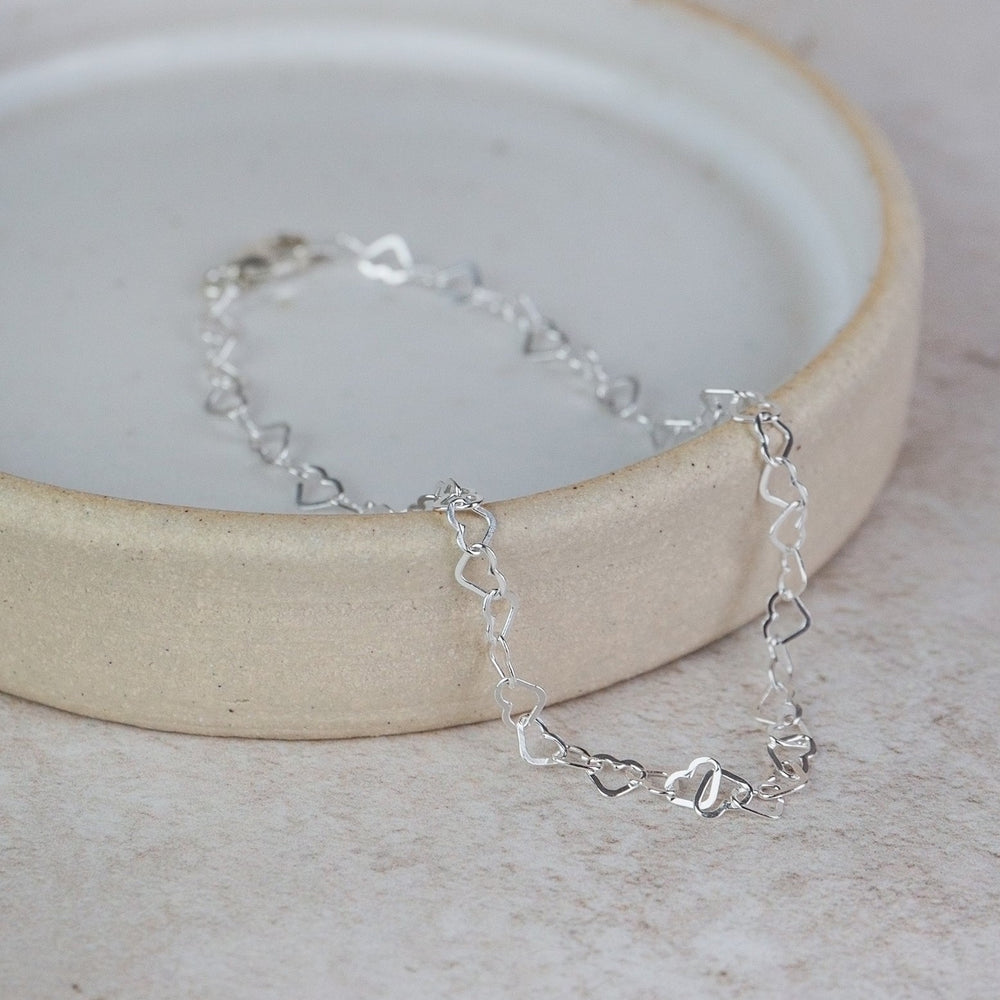 
                  
                    sterling silver mini heart chain link bracelet handmade by Lucy Kemp Jewellery 
                  
                