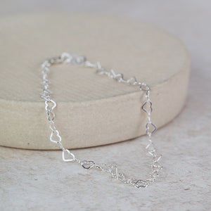 
                  
                    sterling silver mini heart chain link bracelet handmade by Lucy Kemp Jewellery
                  
                