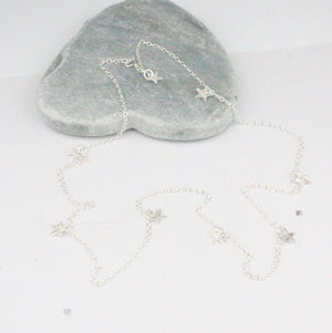 
                  
                    sterling silver short textured star charm necklace by Lucy Kemp Jewellery
                  
                