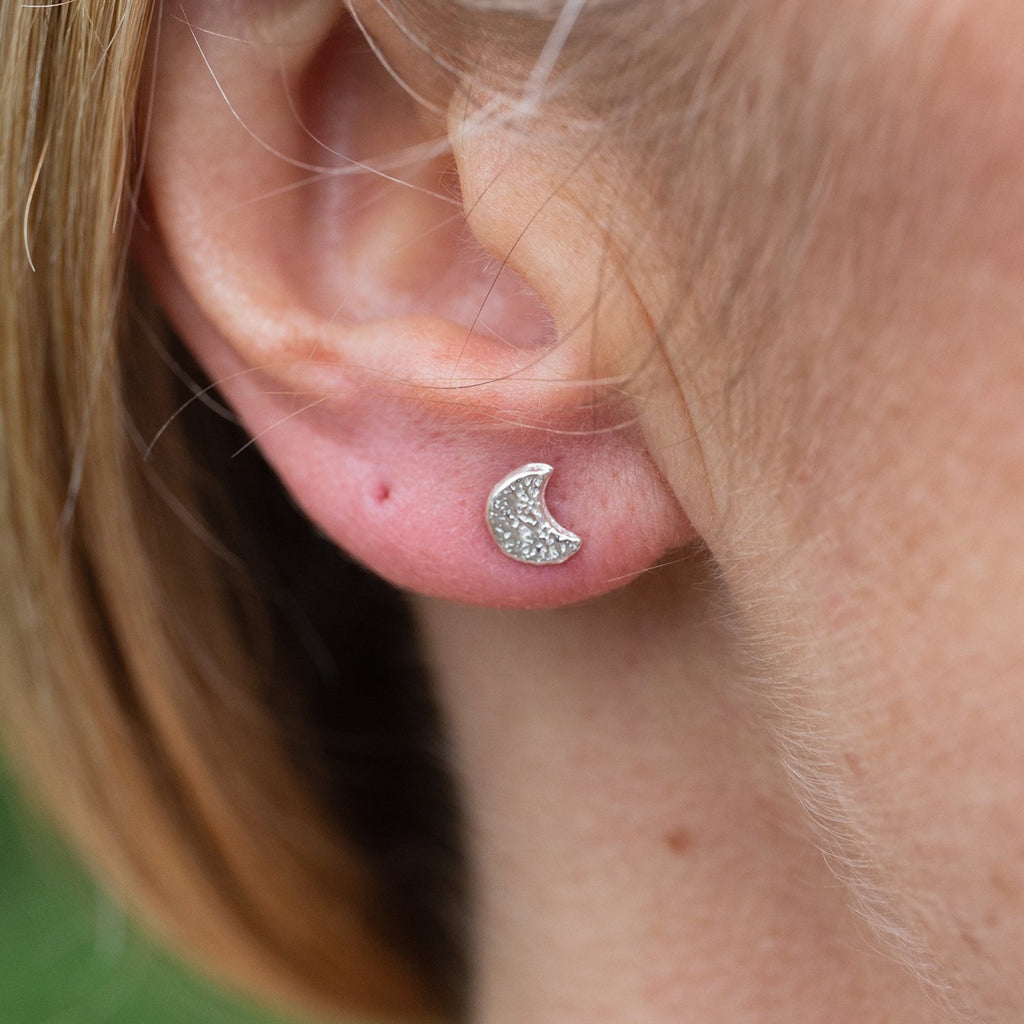 Sterling silver textured mini moon studs worn, handmade by Lucy Kemp Jewellery 