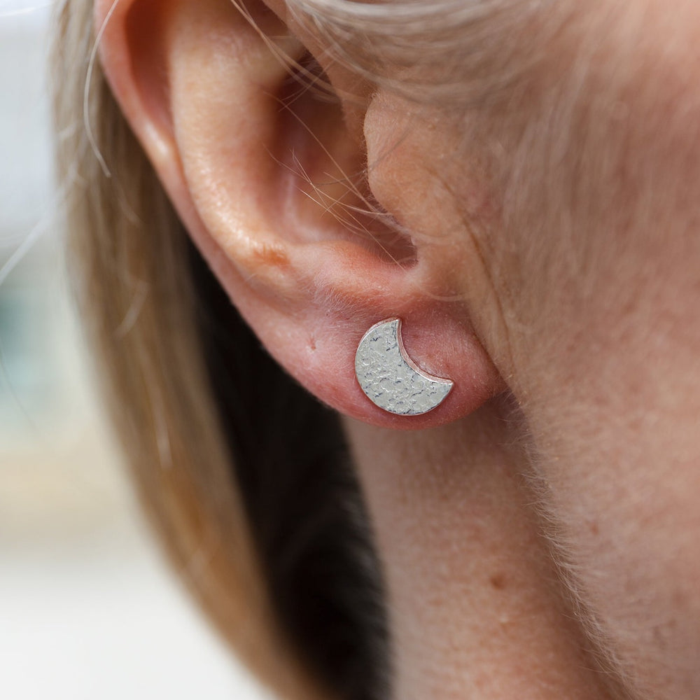 
                  
                    sterling silver textured moon studs worn by Lucy Kemp Jewellery
                  
                