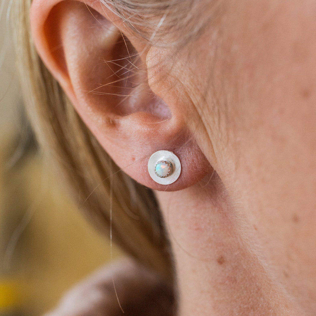 worn Opal and sterling silver birthstone small disc studs by Lucy Kemp Jewellery