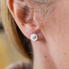 worn Pearl and sterling silver birthstone small disc studs by Lucy Kemp Jewellery