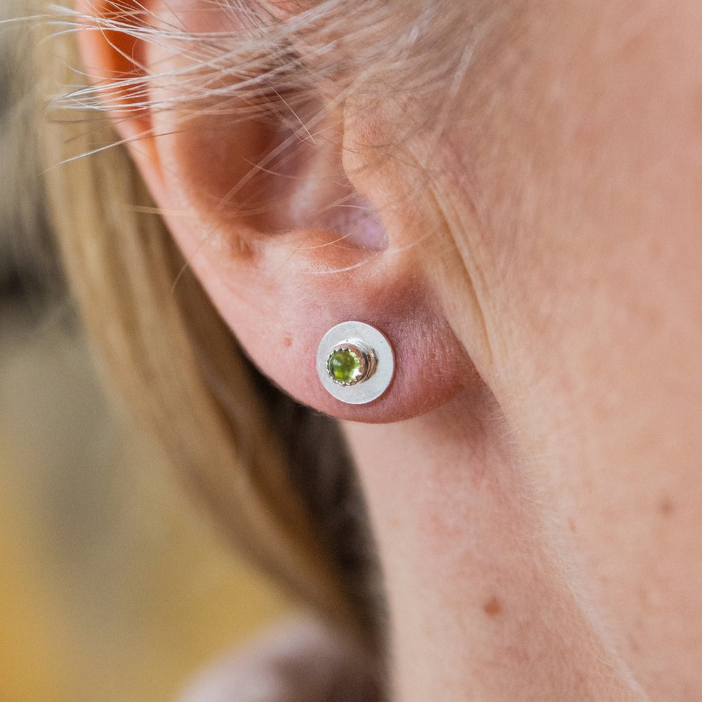 
                  
                    worn Peridot and sterling silver birthstone small disc studs by Lucy Kemp Jewellery
                  
                
