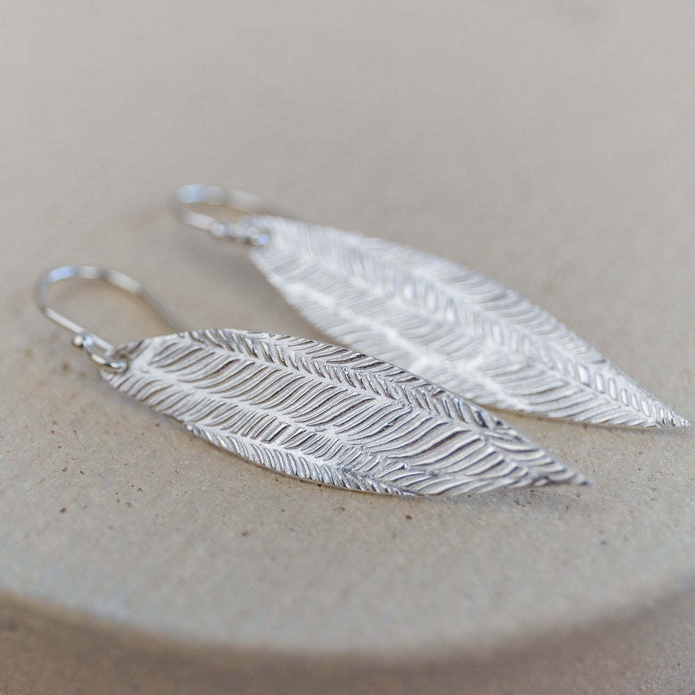 
                  
                    Sterling silver palm leaf textured earrings by Lucy Kemp jewellery
                  
                