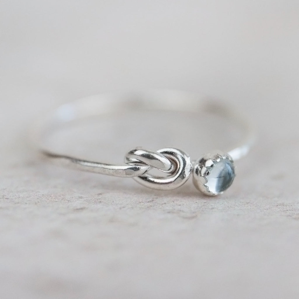 sterling silver birthstone love knot ring by Lucy Kemp Jewellery with Aquamarine