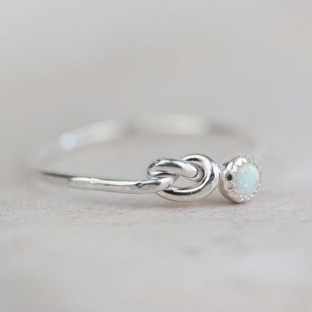 
                  
                    sterling silver birthstone love knot ring by Lucy Kemp Jewellery with opal
                  
                
