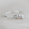 sterling silver birthstone love knot ring by Lucy Kemp Jewellery with opal