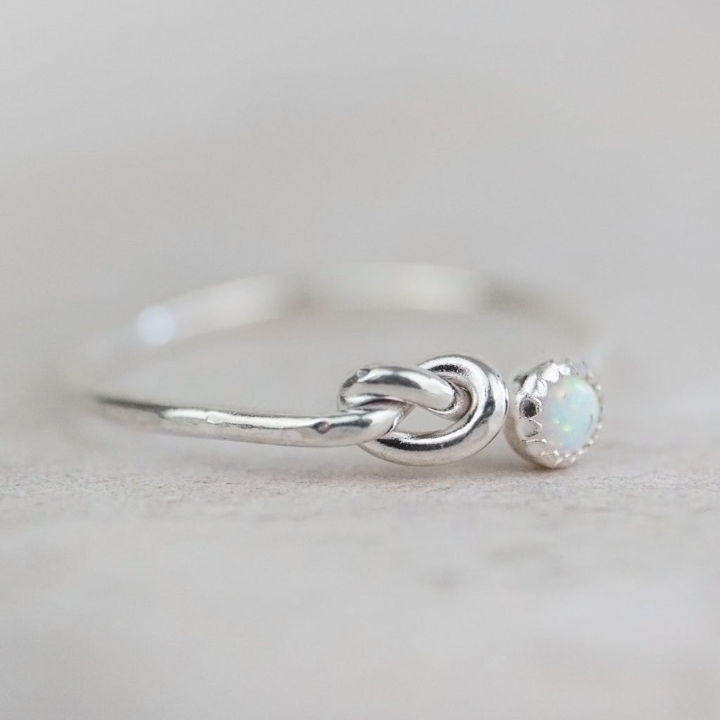 sterling silver birthstone love knot ring by Lucy Kemp Jewellery with opal