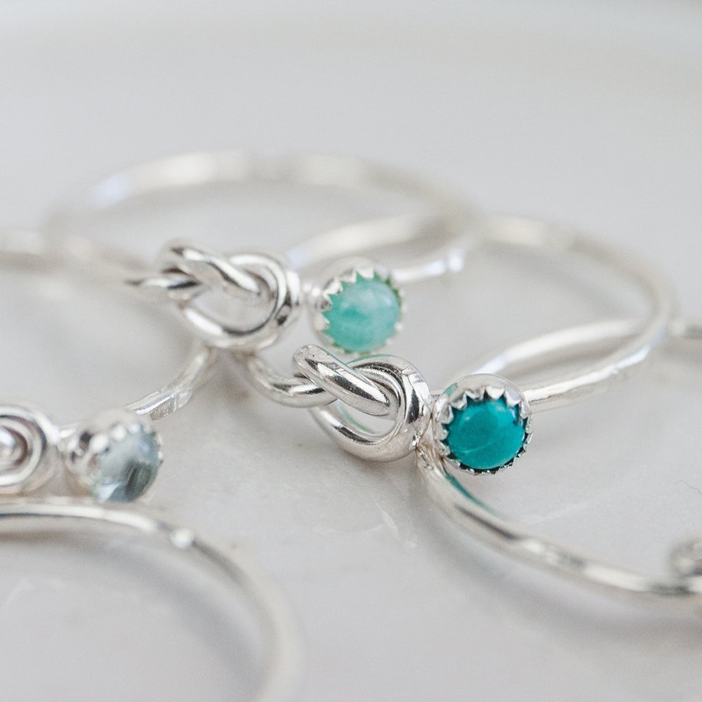 sterling silver birthstone love knot ring group shot by Lucy Kemp Jewellery 