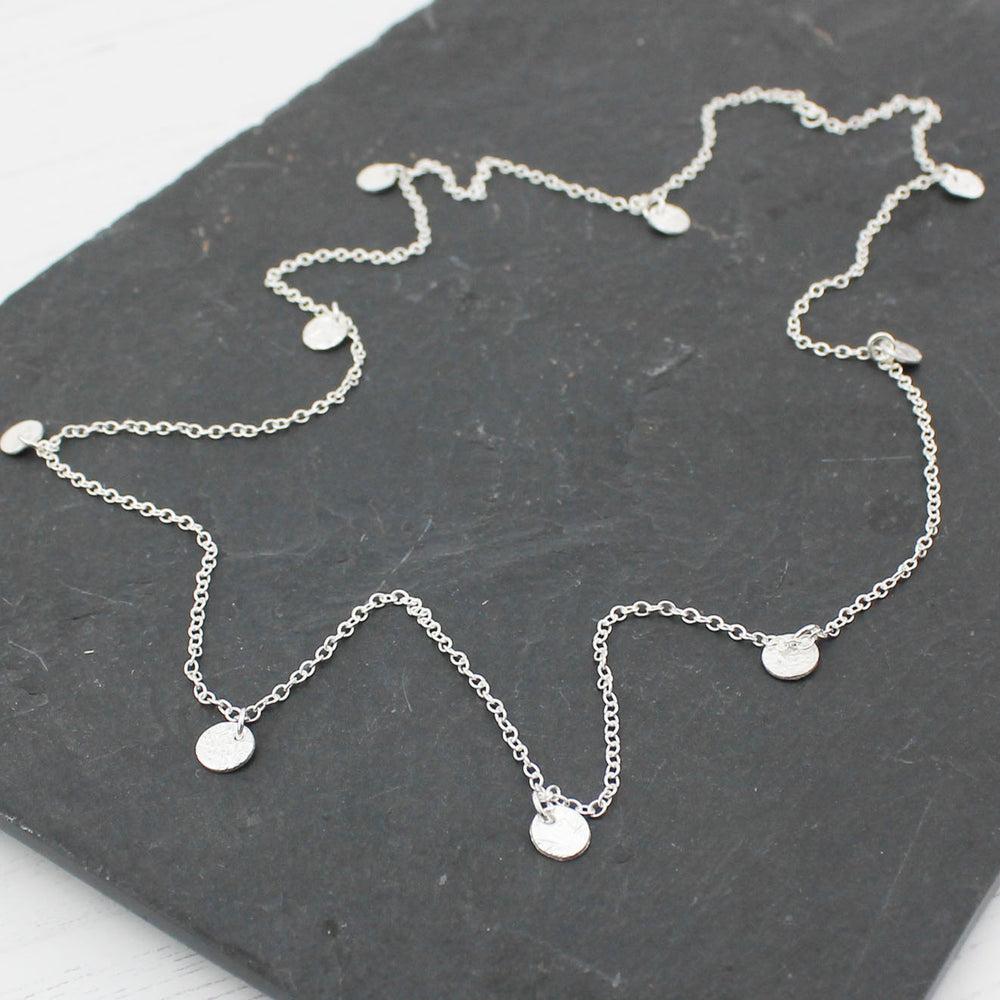 
                  
                    Sterling silver long textured circle charm necklace by Lucy Kemp Jewellery
                  
                