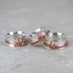 sterling silver spinner ring with copper love knot , handmade by Lucy Kemp Jewellery - group shot