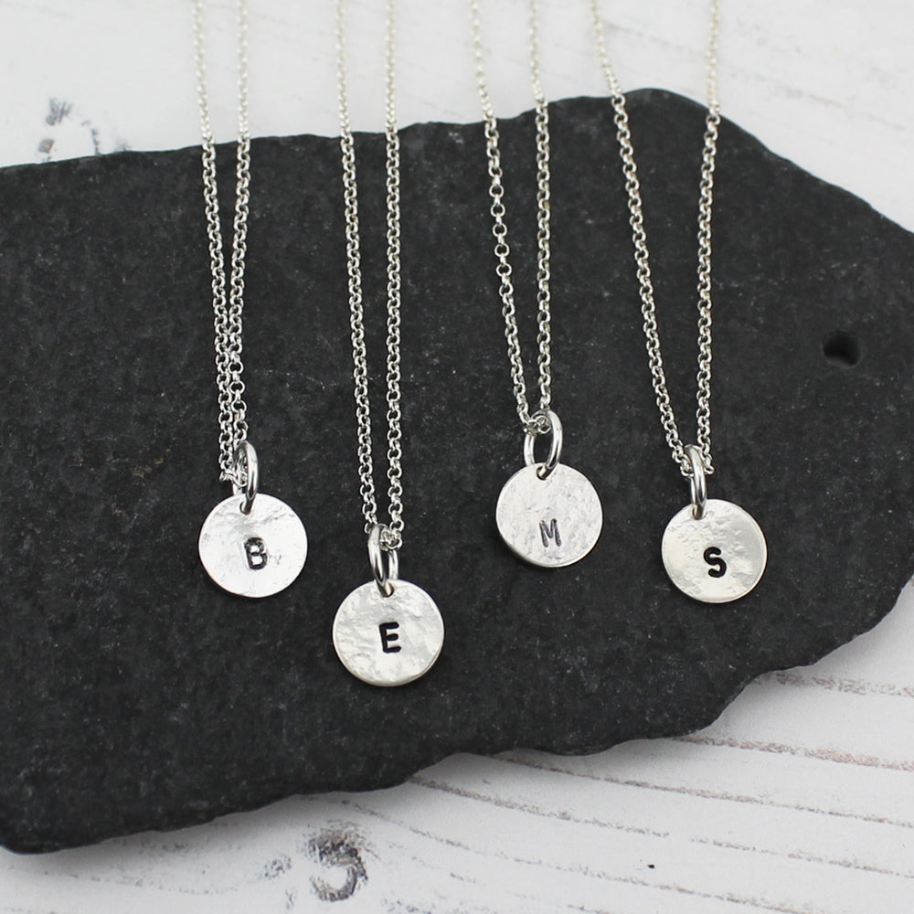 
                  
                    sterling silver stamped initial dinky pendant by Lucy Kemp Jewellery
                  
                