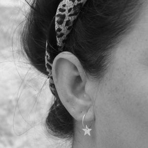 
                  
                    Handmade Lucy Kemp Jewellery Sterling Silver Text Star Charm Hoops worn 
                  
                