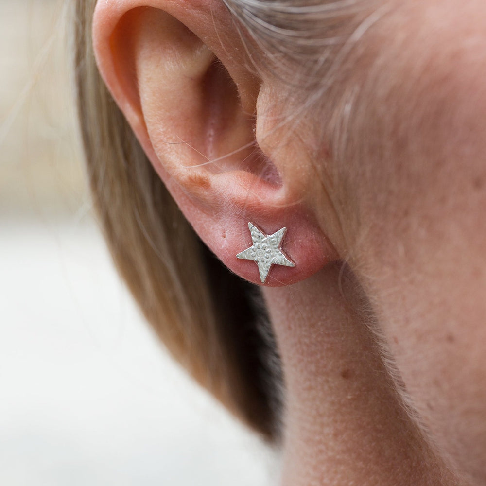 
                  
                    sterling silver textured star stud worn by Lucy Kemp Jewellery
                  
                