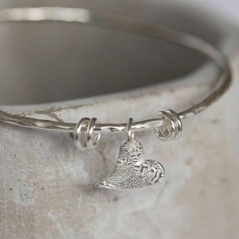 
                  
                    sterling silver textured tilted heart bangle by Lucy Kemp Jewellery
                  
                