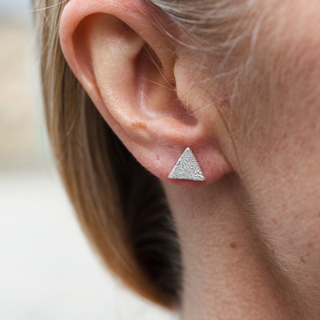 sterling silver textured triangle studs worn by Lucy Kemp Jewellery