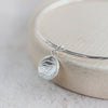 sterling silver small circle cuttlefish charm bangle handmade by Lucy Kemp Jewellery