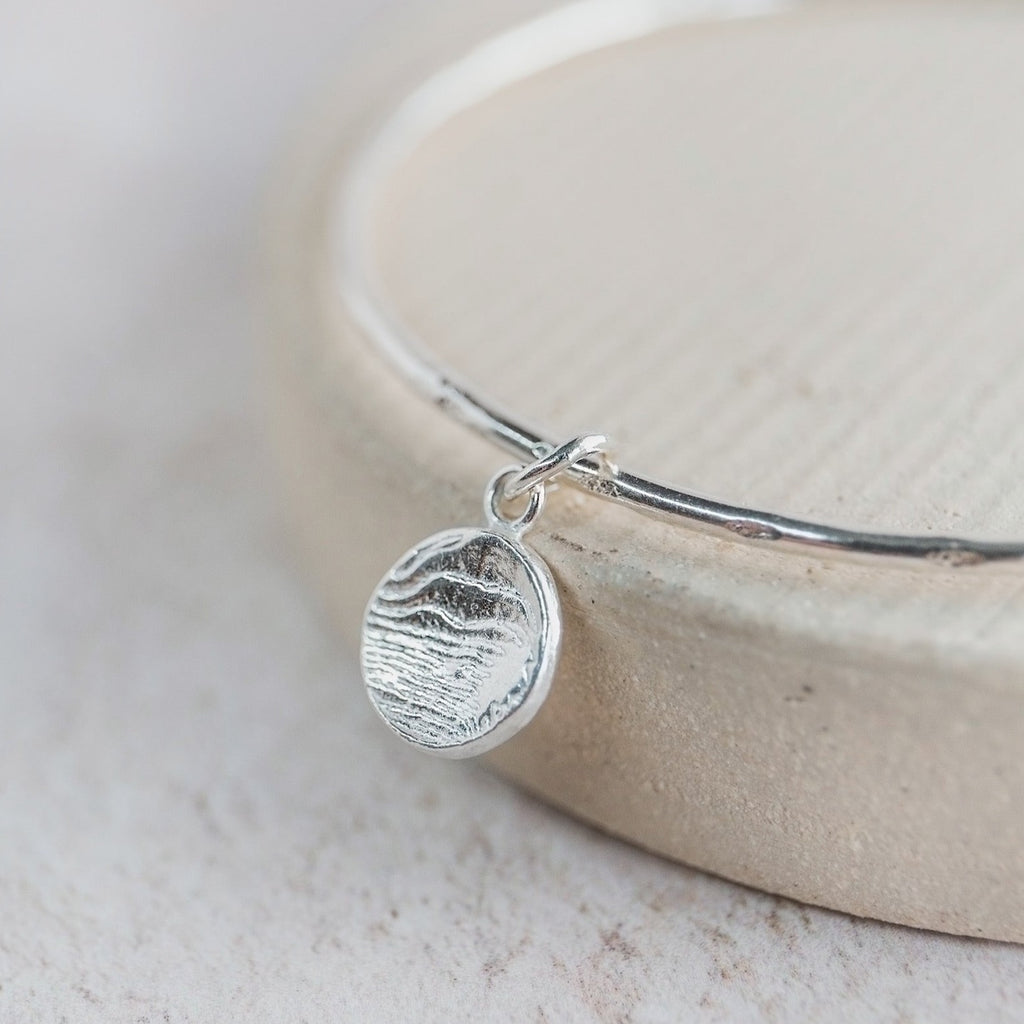 sterling silver small circle cuttlefish charm bangle handmade by Lucy Kemp Jewellery