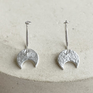 
                  
                    sterling silver crescent moon charm hoops handmade by Lucy Kemp Jewellery
                  
                