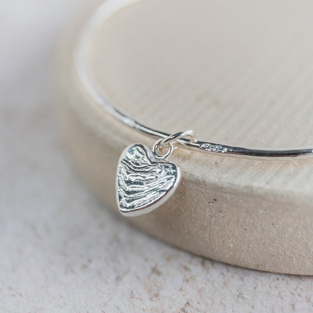 sterling silver small heart cuttlefish charm bangle handmade by Lucy Kemp Jewellery