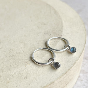 
                  
                    Sterling silver and labradorite birthstone huggie sleeper hoops handmade by Lucy Kemp Jewellery
                  
                
