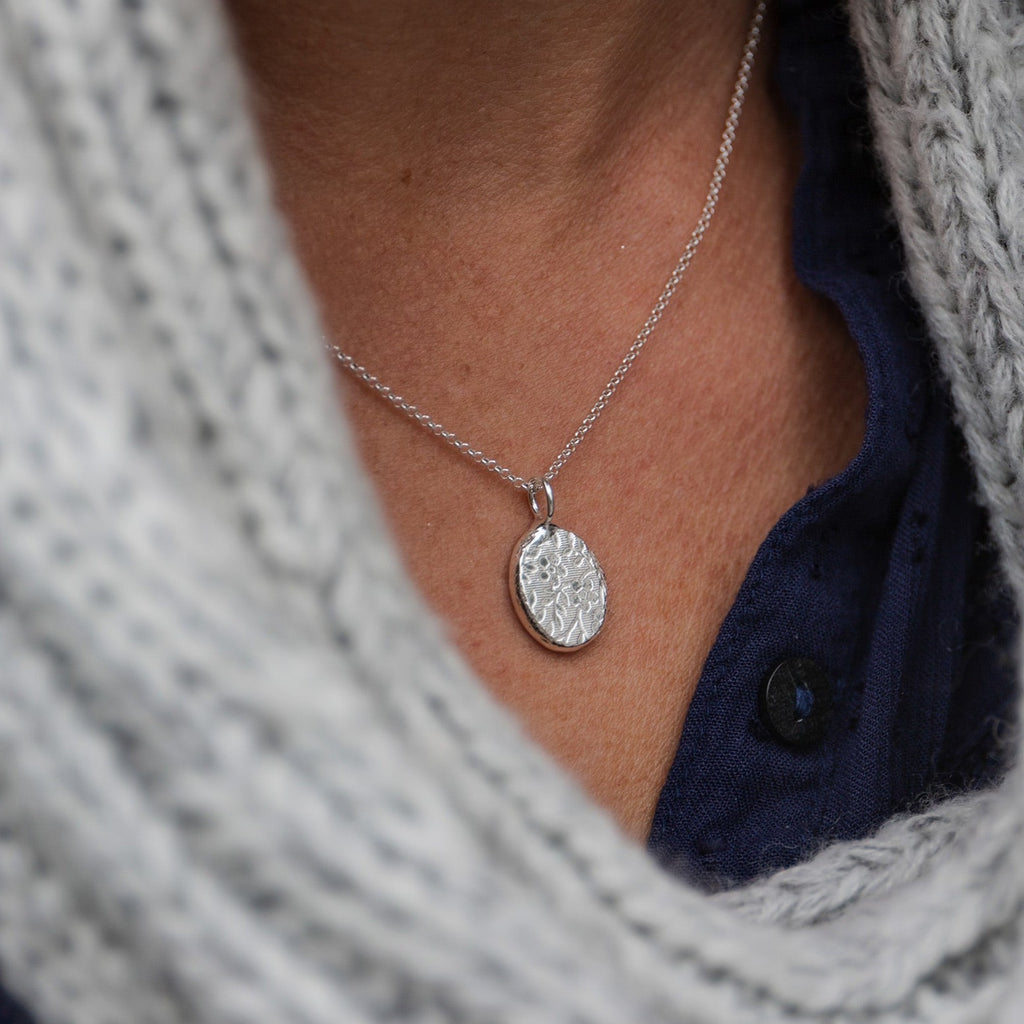 recycled sterling silver textured nugget pendants handmade by Lucy Kemp jewellery - daisy pattern - worn image