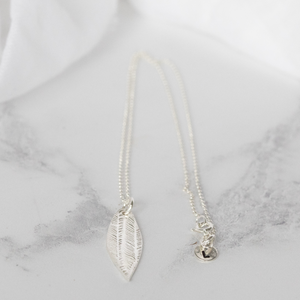 
                  
                    sterling silver textured palm leaf pendant by Lucy Kemp Jewellery
                  
                