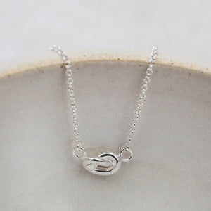 
                  
                    sterling silver love knot necklace by Lucy Kemp jewellery
                  
                