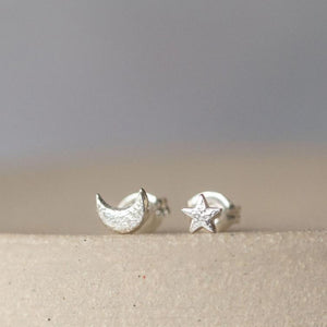 
                  
                    sterling silver textured mini mismatch moon and star studs
                  
                