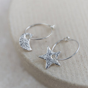 
                  
                    Handmade Sterling Silver Lucy Kemp Jewellery Star and Moon Charm Hoops.
                  
                