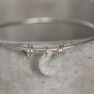 
                  
                    sterling silver textured moon charm bangle handmade by Lucy Kemp Jewellery
                  
                